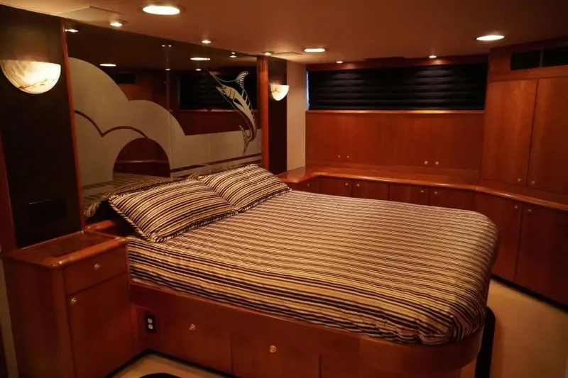 After Midnight Yacht Photos Pics Luxurious yacht bedroom with striped bedding, wooden cabinetry, and elegant lighting, Knight & Carver Lux SF 1994.