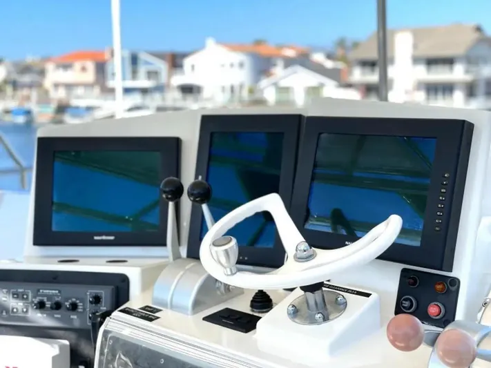 After Midnight Yacht Photos Pics Cockpit of 1994 Knight & Carver Lux SF yacht with modern navigation screens.
