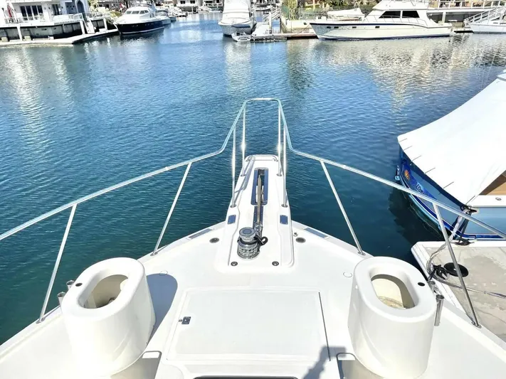 After Midnight Yacht Photos Pics Bow view of 1994 Knight & Carver Lux SF yacht in a marina.