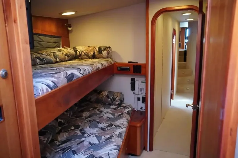 After Midnight Yacht Photos Pics Interior of 1994 Knight & Carver Lux SF yacht with bunk beds and hallway view.