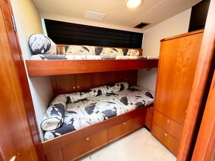 After Midnight Yacht Photos Pics Bunk beds in a 1994 Knight & Carver Lux SF yacht cabin with wood finish and patterned bedding.