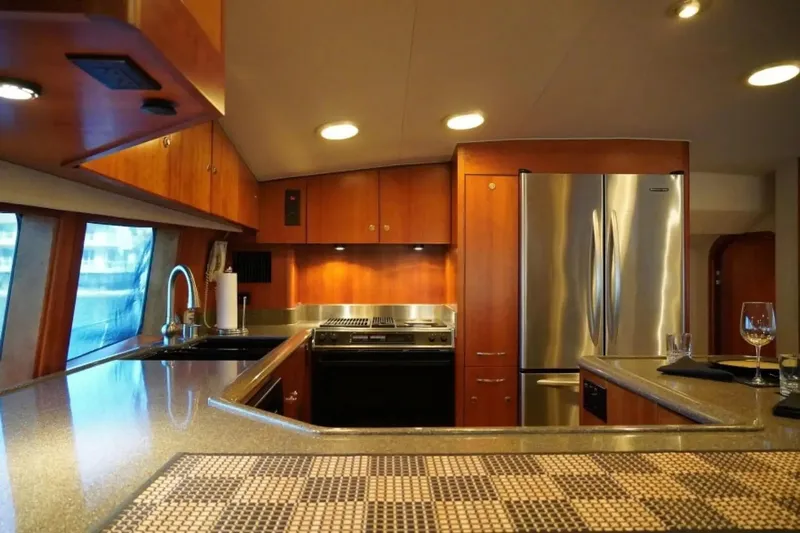 After Midnight Yacht Photos Pics Luxurious yacht kitchen with modern appliances, wooden cabinetry, and elegant lighting, Knight & Carver Lux SF 1994.