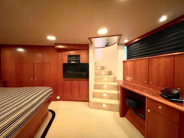 After Midnight Yacht Photos Pics Luxurious yacht interior with wooden cabinetry, stairs, and a flat-screen TV, Knight & Carver Lux SF 1994.