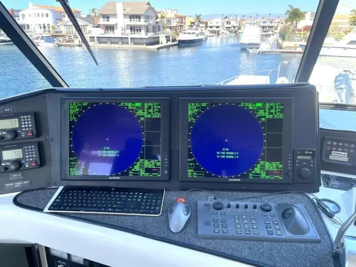 After Midnight Yacht Photos Pics Control panel of a 1994 Knight & Carver Lux SF yacht with dual navigation screens.
