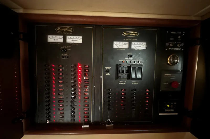 Miss Cissa Yacht Photos Pics Electrical control panel of a 2003 Rampage 38 Express boat, featuring switches and gauges.