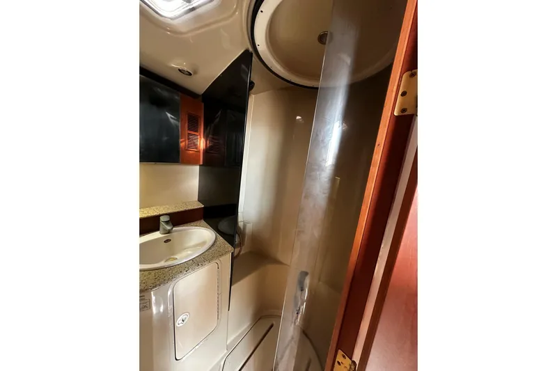 Miss Cissa Yacht Photos Pics 2003 Rampage 38 Express bathroom with sink, shower, and storage cabinets.