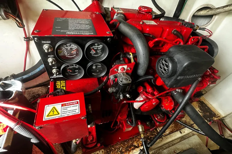 Miss Cissa Yacht Photos Pics Engine compartment of a 2003 Rampage 38 Express boat, featuring red mechanical components.