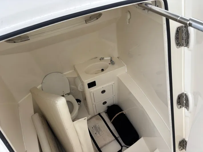  Yacht Photos Pics 2021 Cobia 301 Center Console boat interior with toilet and sink.