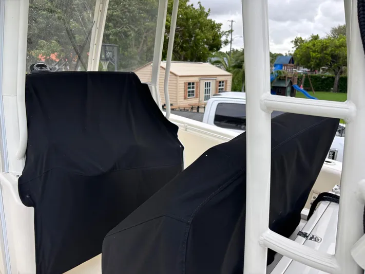  Yacht Photos Pics 2021 Cobia 301 Center Console boat seats with black covers, outdoor setting.