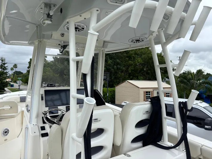  Yacht Photos Pics 2021 Cobia 301 Center Console boat interior with rod holders and navigation equipment.