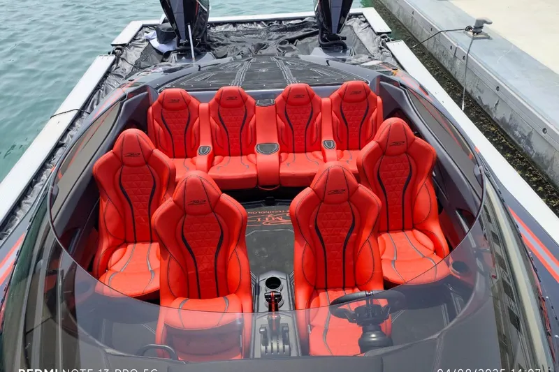  Yacht Photos Pics Luxury MTI 440X 2025 speedboat with vibrant red seating, docked at marina.