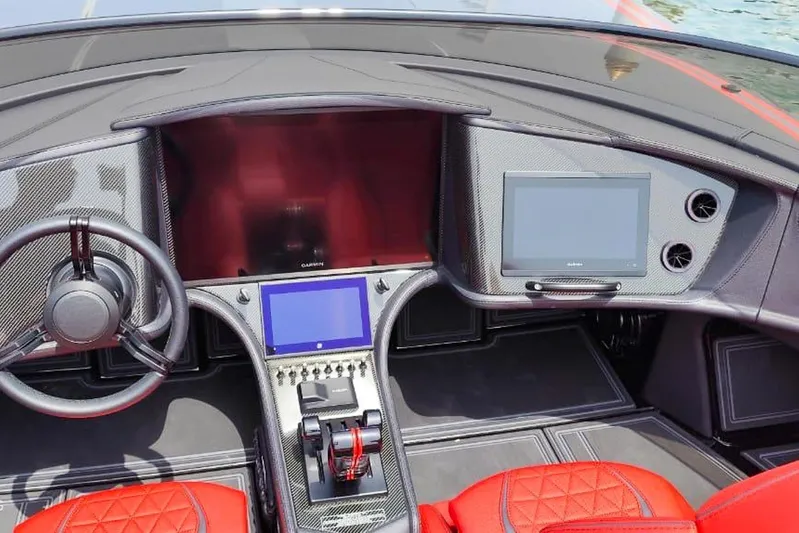  Yacht Photos Pics Interior of 2025 MTI 440X boat with advanced navigation displays and red leather seats.