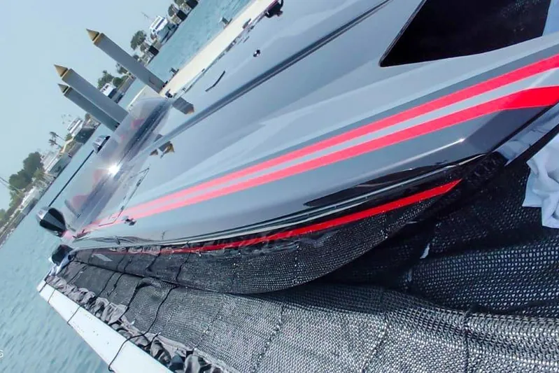  Yacht Photos Pics 2025 MTI 440X speedboat with sleek design and red accents docked by the water.