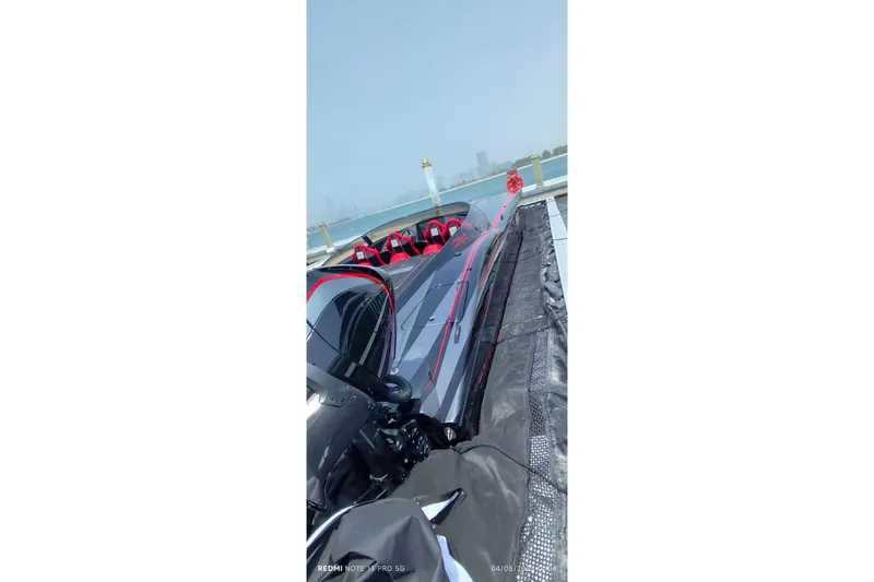  Yacht Photos Pics 2025 MTI 440X speedboat docked, featuring sleek black and red design.