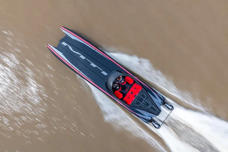  Yacht Photos Pics Aerial view of 2025 MTI 440X speedboat racing on water.