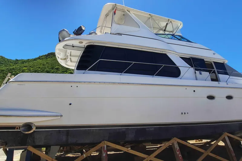  Yacht Photos Pics 2000 Carver 530 Voyager Pilothouse yacht on dry dock under clear blue sky.