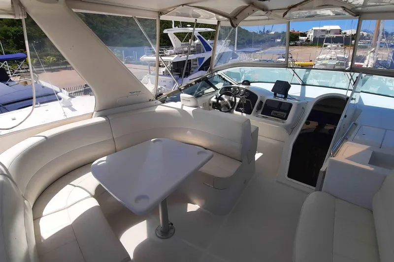 Yacht Photos Pics 2000 Carver 530 Voyager Pilothouse interior with helm, seating, and table in marina setting.