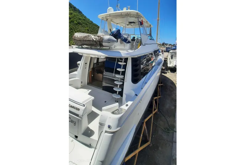  Yacht Photos Pics Carver 530 Voyager Pilothouse 2000 yacht docked, showcasing sleek design and spacious deck.