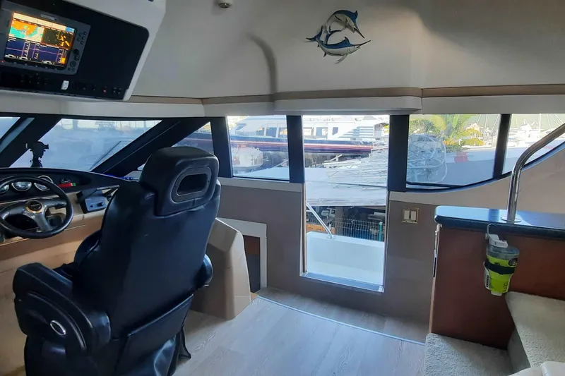  Yacht Photos Pics Interior of 2000 Carver 530 Voyager Pilothouse with helm and panoramic windows.