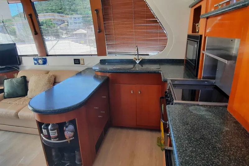  Yacht Photos Pics Luxurious kitchen interior of 2000 Carver 530 Voyager Pilothouse yacht with modern amenities.