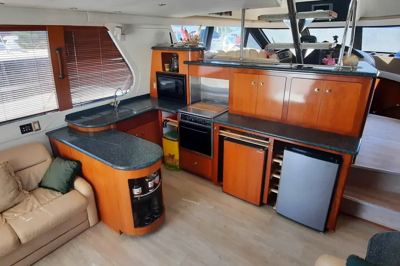  Yacht Photos Pics Interior of 2000 Carver 530 Voyager Pilothouse with modern kitchen and seating area.