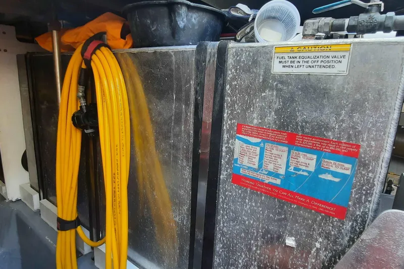  Yacht Photos Pics Engine room of 2000 Carver 530 Voyager Pilothouse with yellow hose and caution signs.