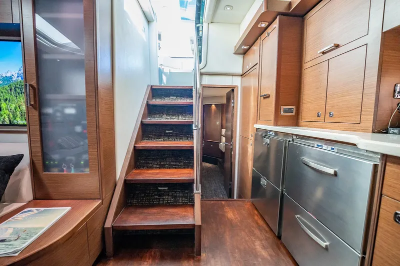 No Shoes Yacht Photos Pics Interior of 2013 Sea Ray 580 Sundancer yacht with modern kitchen and wooden stairs.