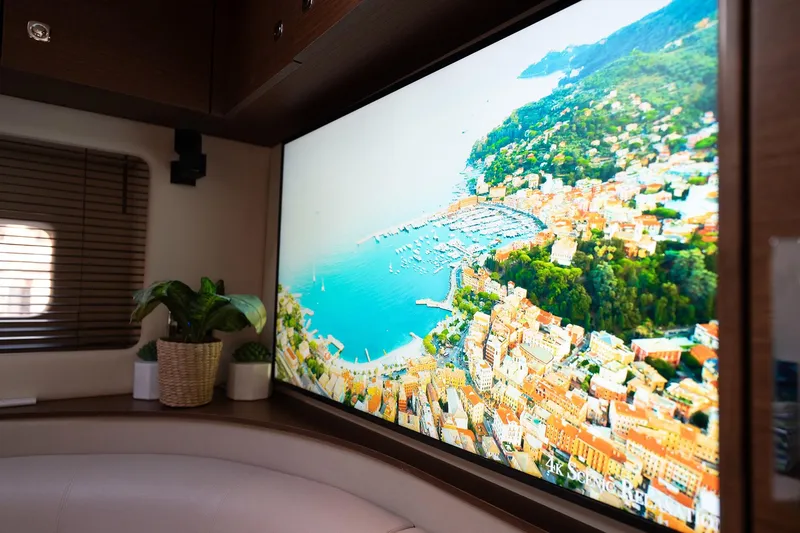 No Shoes Yacht Photos Pics Luxurious interior of 2013 Sea Ray 580 Sundancer yacht with large scenic screen display.