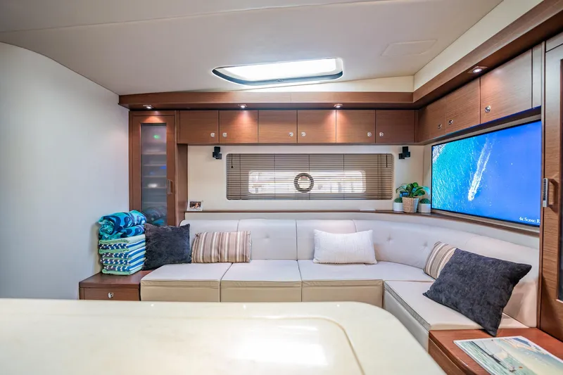 No Shoes Yacht Photos Pics Luxurious interior of 2013 Sea Ray 580 Sundancer yacht with cozy seating and modern decor.