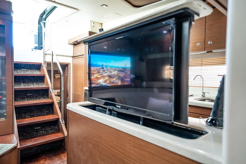 No Shoes Yacht Photos Pics Interior of 2013 Sea Ray 580 Sundancer yacht with TV and staircase.