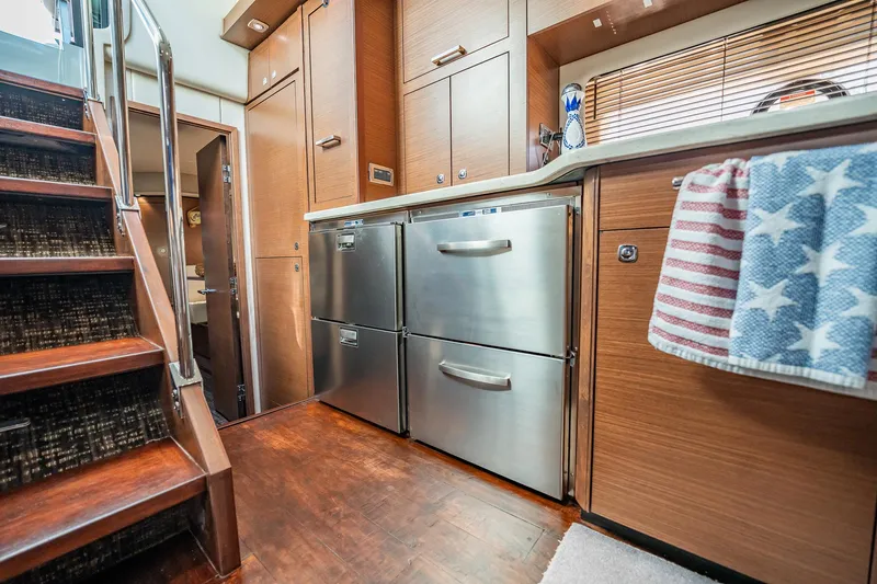 No Shoes Yacht Photos Pics Interior of 2013 Sea Ray 580 Sundancer yacht with modern kitchen and wooden stairs.