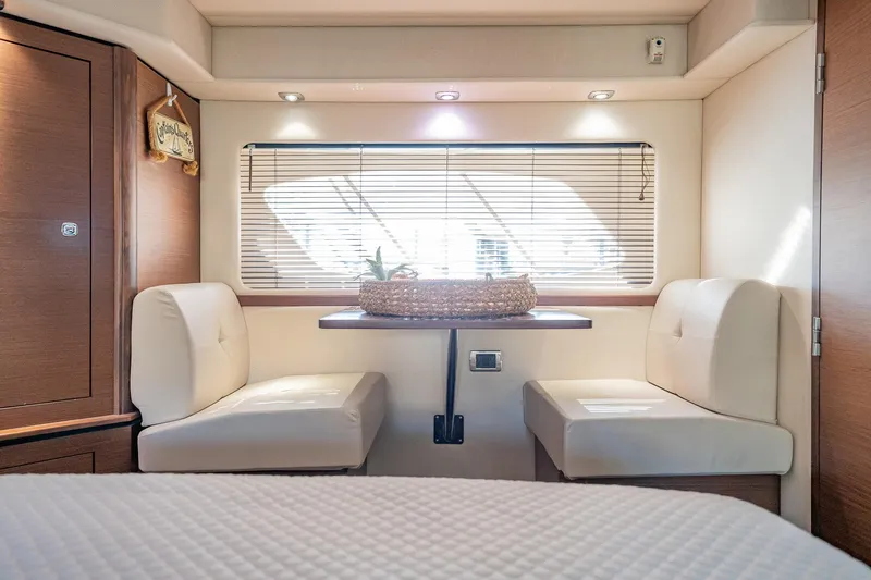 No Shoes Yacht Photos Pics Interior of 2013 Sea Ray 580 Sundancer yacht with cozy seating and window blinds.