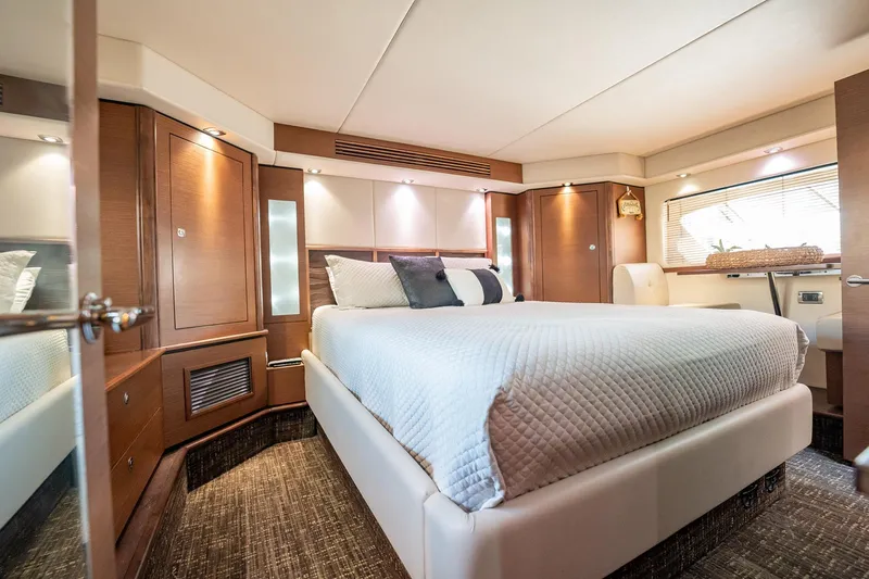 No Shoes Yacht Photos Pics Luxurious bedroom interior of 2013 Sea Ray 580 Sundancer yacht with elegant furnishings.
