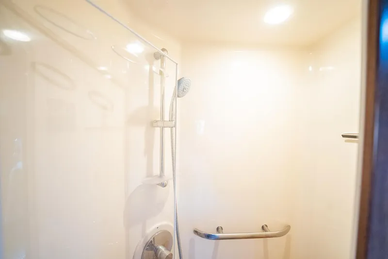 No Shoes Yacht Photos Pics Shower area in 2013 Sea Ray 580 Sundancer yacht, featuring modern fixtures and lighting.