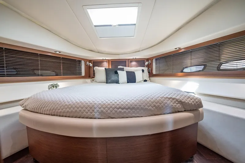 No Shoes Yacht Photos Pics Luxurious cabin interior of 2013 Sea Ray 580 Sundancer yacht with cozy bed and elegant design.