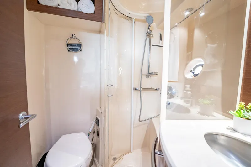 No Shoes Yacht Photos Pics Luxurious bathroom in 2013 Sea Ray 580 Sundancer yacht with shower and modern amenities.