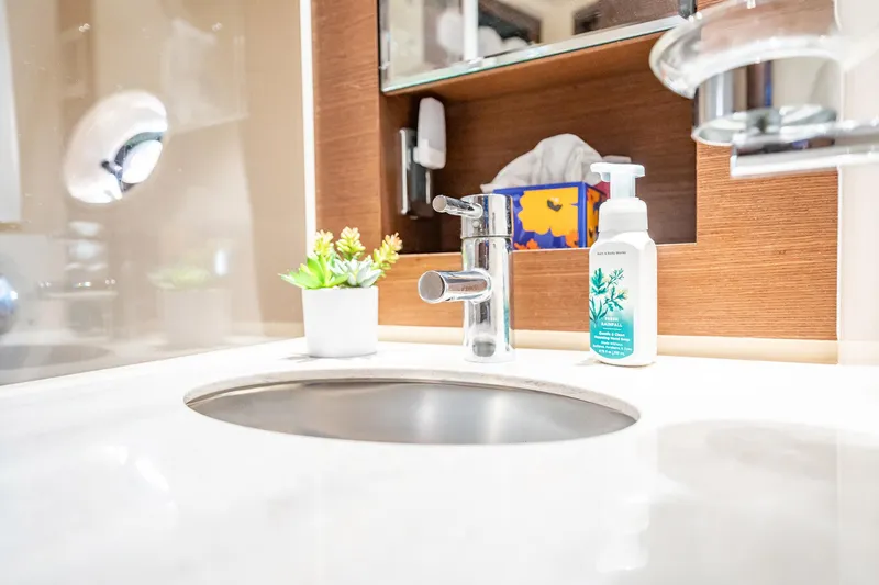 No Shoes Yacht Photos Pics Luxurious bathroom sink on 2013 Sea Ray 580 Sundancer yacht with modern fixtures and decor.