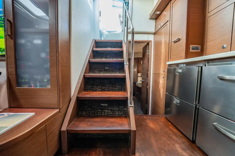 No Shoes Yacht Photos Pics Interior of 2013 Sea Ray 580 Sundancer yacht, featuring wooden stairs and modern kitchen appliances.