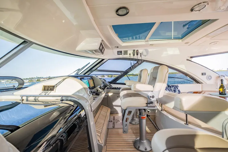 No Shoes Yacht Photos Pics Luxurious interior of 2013 Sea Ray 580 Sundancer yacht with modern helm and seating.