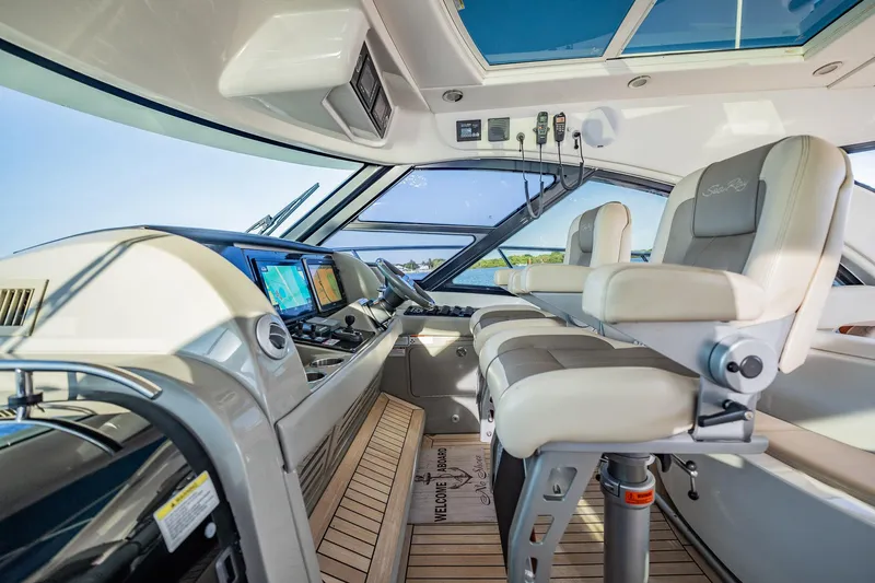 No Shoes Yacht Photos Pics Luxurious 2013 Sea Ray 580 Sundancer yacht cockpit with modern navigation equipment and plush seating.