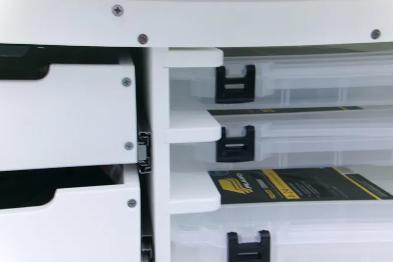  Yacht Photos Pics Storage compartments on a 2026 Blackfin 262 HB boat, featuring organized tackle boxes.