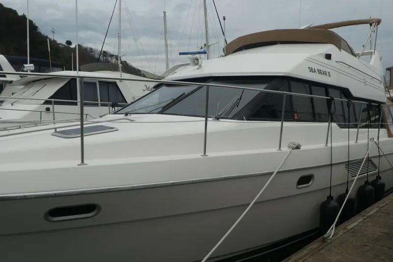  Yacht Photos Pics 1994 Bayliner 4388 Motor Yacht docked at marina, side view.