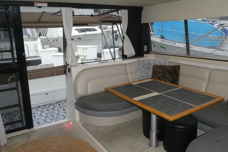  Yacht Photos Pics Interior of 1994 Bayliner 4388 Motor Yacht with dining area and marina view.
