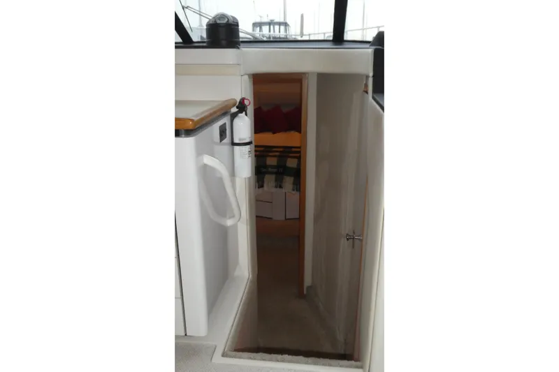  Yacht Photos Pics 1994 Bayliner 4388 Motor Yacht interior with open cabin door and fire extinguisher.