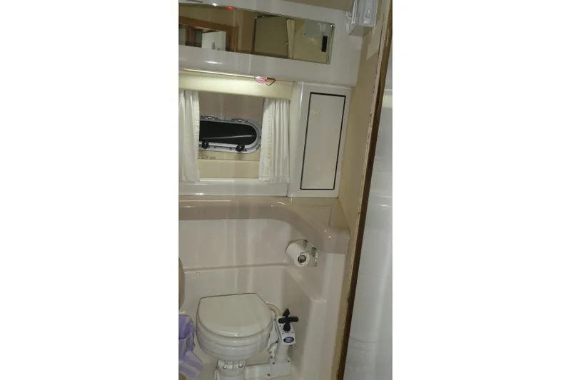  Yacht Photos Pics Bathroom interior of 1994 Bayliner 4388 Motor Yacht with toilet and mirror.