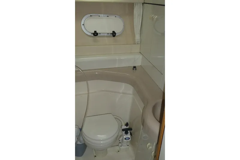  Yacht Photos Pics Bathroom interior of 1994 Bayliner 4388 Motor Yacht with compact design and porthole window.