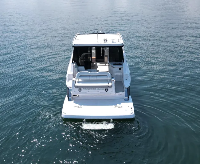 Princess Maya Yacht Photos Pics 2024 Regal 36 Grande Coupe on calm water, rear view.