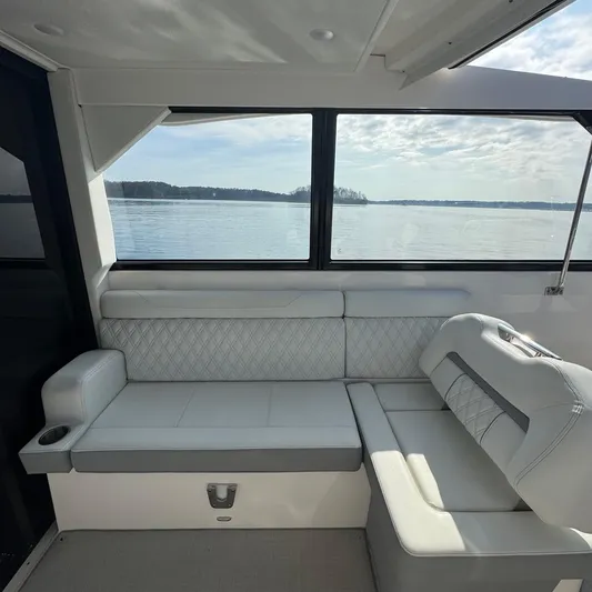 Princess Maya Yacht Photos Pics Interior of 2024 Regal 36 Grande Coupe with lake view through large windows.