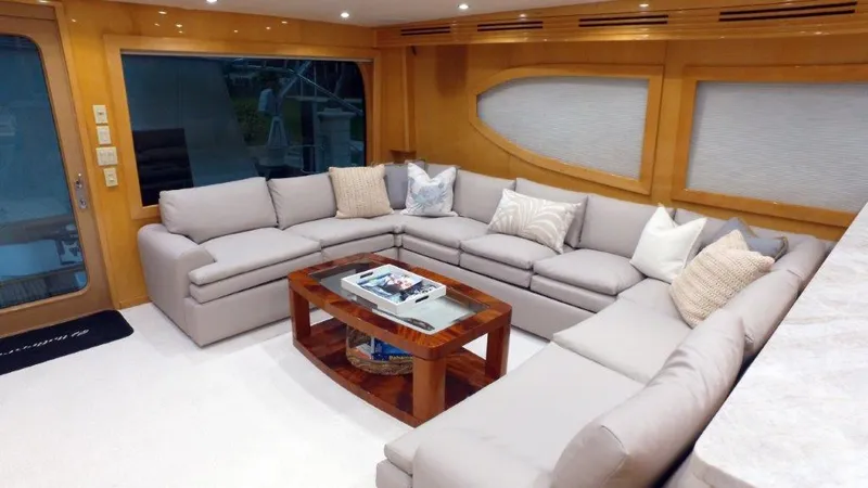 Jolley Roger Yacht Photos Pics Luxurious 2006 Hatteras Enclosed Bridge yacht interior with plush seating and elegant decor.