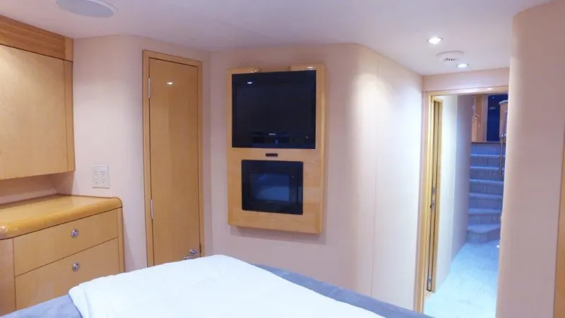 Jolley Roger Yacht Photos Pics 2006 Hatteras Enclosed Bridge interior with TV, wooden cabinetry, and hallway view.